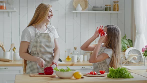 Adult Mother Housewife Cuts Red Pepper Vegetable Ingredient Salad Daughter Child Teen Girl Helps Mom alt