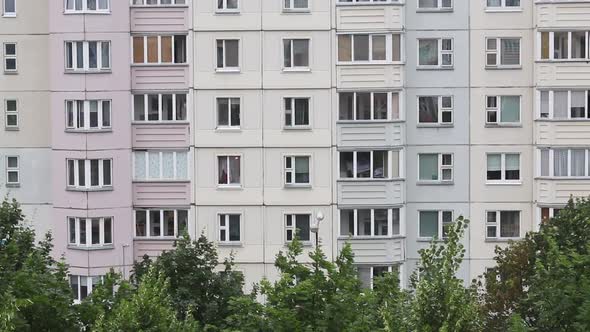 Windows Of A Multi Storey Panel Building. At The Bottom Of The Frame, The Tops Of The Trees alt