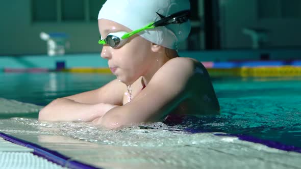 Handsome Young Girl Emerges From Under Water in the Swimming Pool. alt