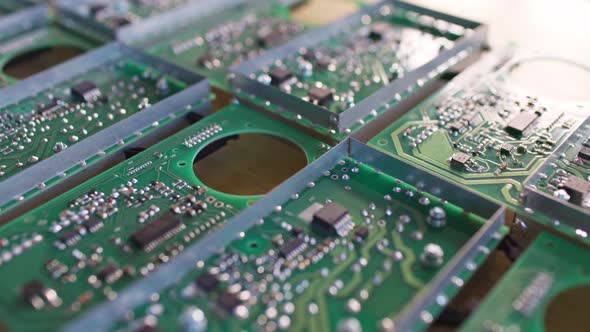 Slider Shot of a Connectors Component and Large Green Microcircuit in Workshop Laboratory alt