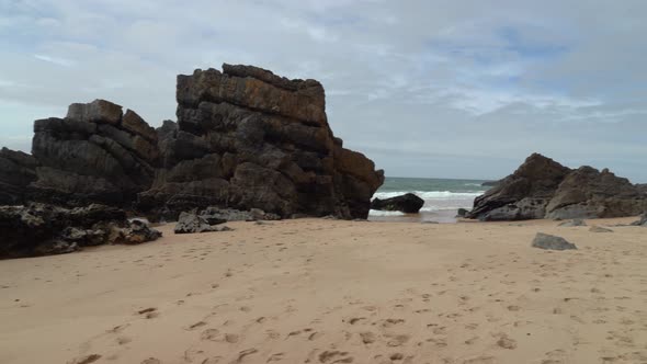 Black Sharp Stones on the Beach near Gruta da Adraga Mountain Range alt