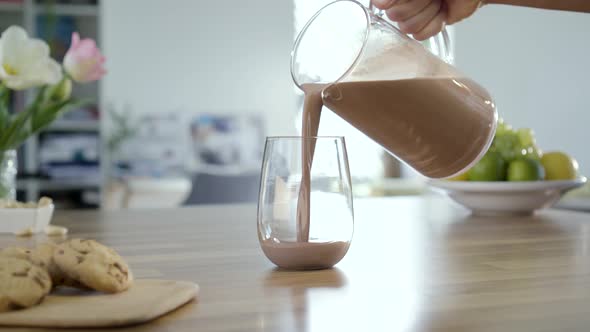 Pouring Chocolate Milk In To Glass