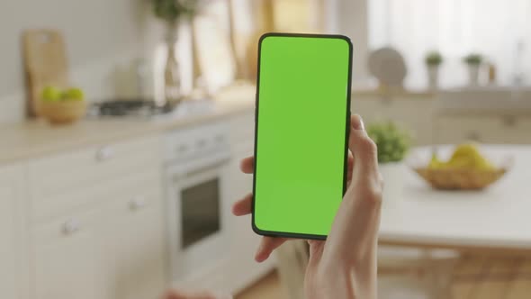 Back View of Woman at Phone with Green Screen for Copy Space