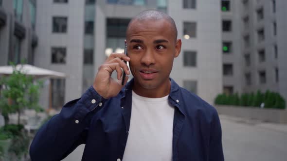 Ethnic Man Answering Phone Call on Street alt