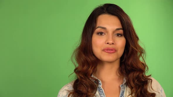 A Young Beautiful Caucasian Woman Talks to the Camera with a Smile  Closeup  Green Screen