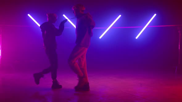 Cool Couple Dancing Playfully in Nightclub alt