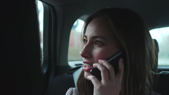 Beautiful Woman On Smartphone In Car