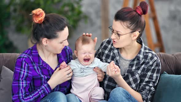 Samesex Couple Parent Having Love Feeling to Little Cute Sad Crying Baby Medium Shot alt