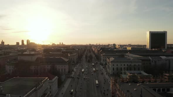 AERIAL: Scenic Low Flight Through Busy Berlin, Germany Street Towards Brandenburg Gate in Beautiful alt