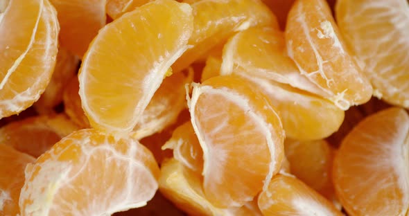 Slices of Ripe Mandarin Rotate Slowly alt