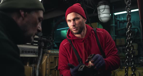 Male Technician Showing Detail to Colleague alt