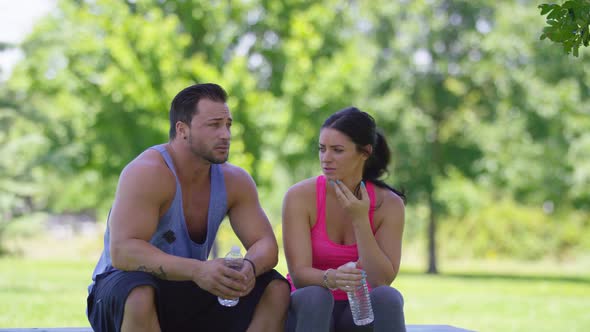 Couple at park take a water break