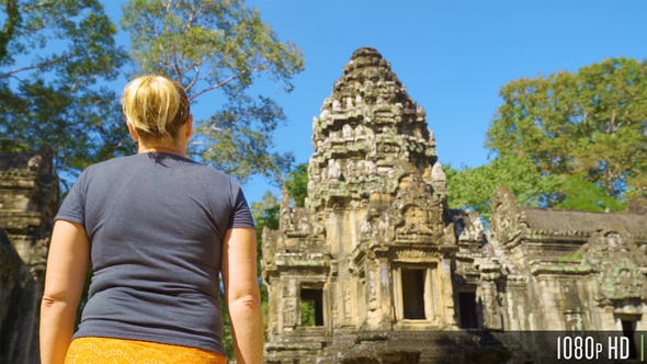 Following Back of Woman Walking to Thommanon Temple in Siem Reap, Cambodia alt