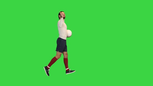 Football Player Running in Front of the Stands After He Scored on a Green Screen Chroma Key alt