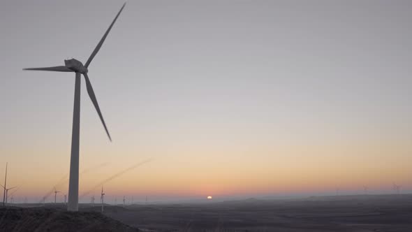 Windmills in operation at sunrise