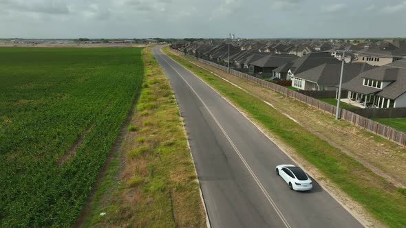 Tesla zero to sixty acceleration test. Aerial on road in USA. Fast white car on wide open road in Am alt