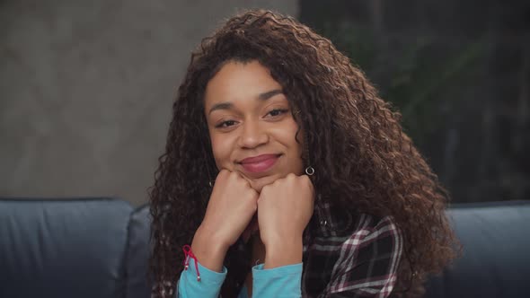 Positive Smiling Female Propping Up Chin with Hands alt