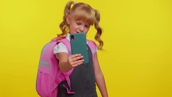 Schoolgirl Kid Blogger in Uniform Taking Selfie Recording Video on Mobile Phone for Social Media alt