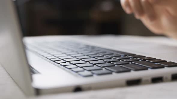 Female Hands are Typing on the Laptop Keyboard alt