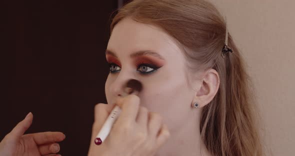 Beautiful girl has her makeup done in a beauty salon.