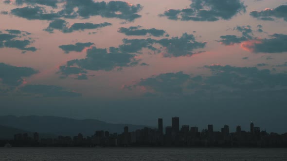 Time lapse of Sunrise over Vancouver Skyline with beautiful clouds alt