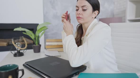 Overworked Young Woman Waking Up in Office and Talking on the Phone alt
