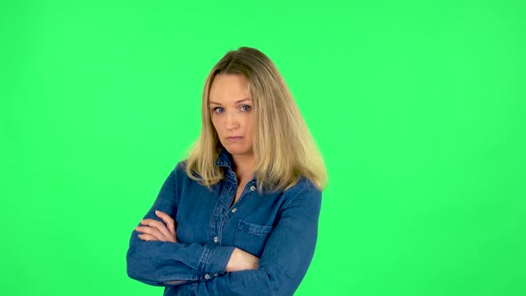 Portrait of Fair Woman Is Standing Offended and Then Smiling. Green Screen alt