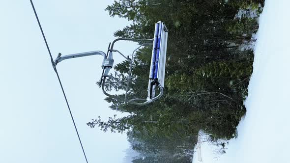 POV Empty Ski Lift Snowy Mountain Winter Forest with Chair Lift At The Ski Resort in Winter alt