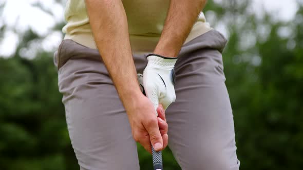 Young golfer hitting golf ball on a course alt