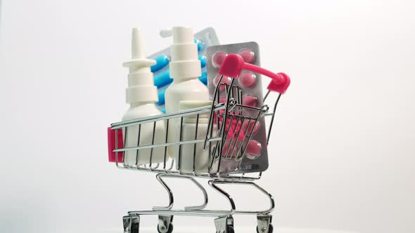 Medicines In A Trolley From A Supermarket On A White Background Spinning, Nasal Spray With Pills