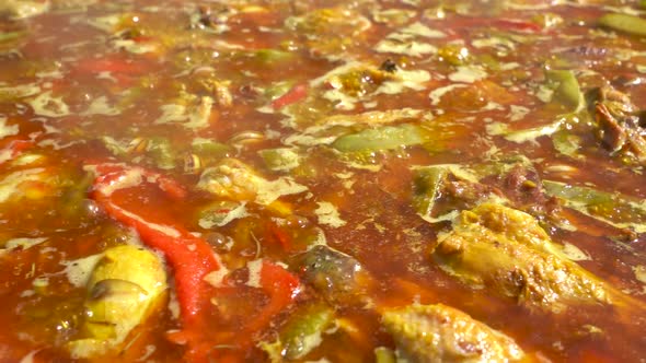 Valencian paella boiling before throwing the rice alt