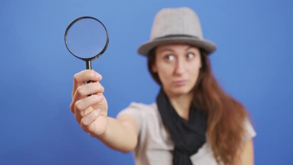 Funny Girl Looking Throw Magnifier To the Camera  alt