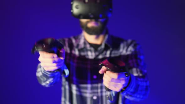 Close-up of Controllers From VR, Shoots in a Shooter Virtual Reality Game. Man Wearing VR Headset on alt