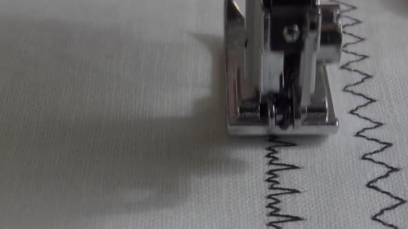 Sewing machine with fabric and thread, closeup. alt