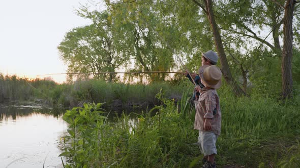 Happy Childhood, Healthy Joyful Male Children Enjoy Summer Vacation Fishing on River Bank at Rural alt