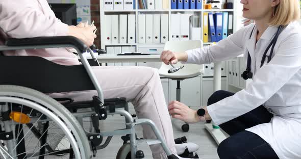 Female Patient in Wheelchair Visits Doctor and is Diagnosed with Leg Numbness alt