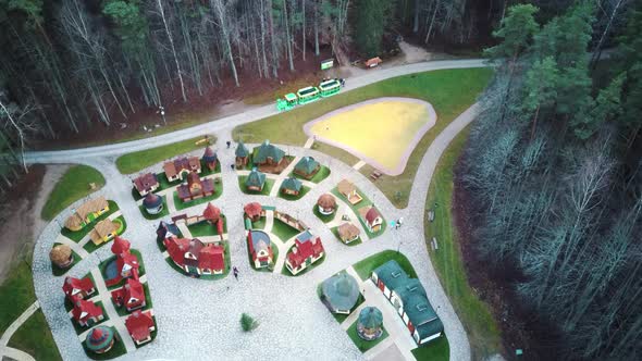 Park in Forest With Wooden Statues of Gnomes, Monsters.  Aerial View of the Wooden Castle 4K Video alt