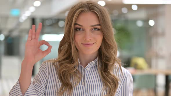 Portrait of Beautiful Businesswoman Showing OK Sign alt