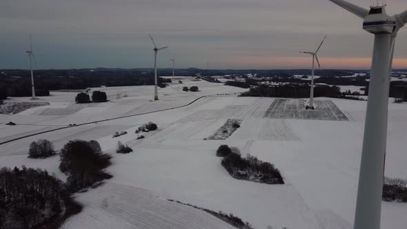 Aerial view of a wind farm in winter. Aerial view of rotating wind turbines.