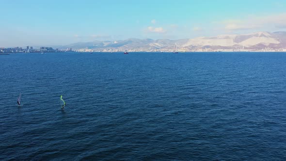 Aerial View of Windsurfer Surfing in in Calm Deep Blue of Sea, Extreme Sport alt