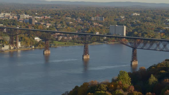 Aerial of walkway over Hudson river and town at a distance alt