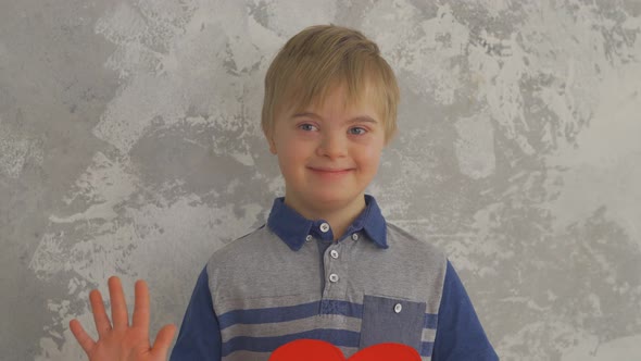 Sweet Little Boy with Down Syndrome with Paper Heart