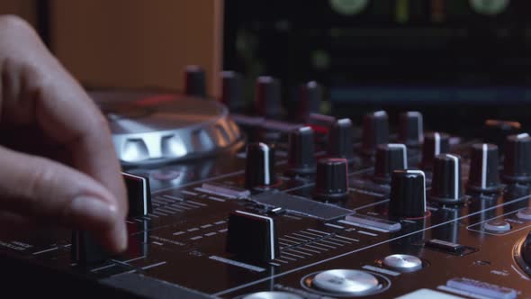 Hands Of DJ Controlling Digital Mixer 06
