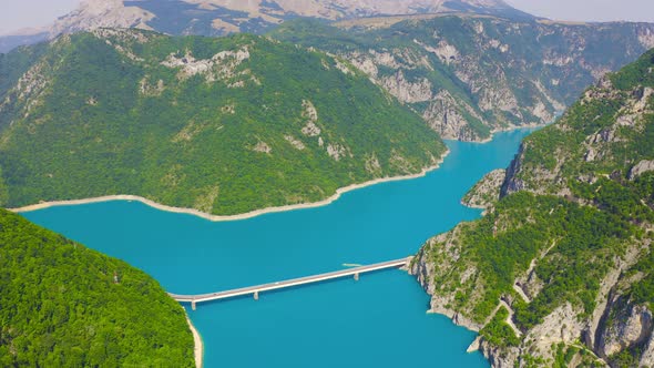 Aerial Topview on Bridge Over Lake Piva with Mountains Canyon in Montenegro alt