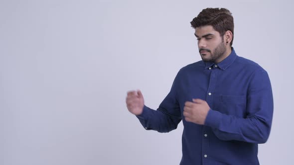 Happy Young Bearded Indian Businessman Showing Something alt