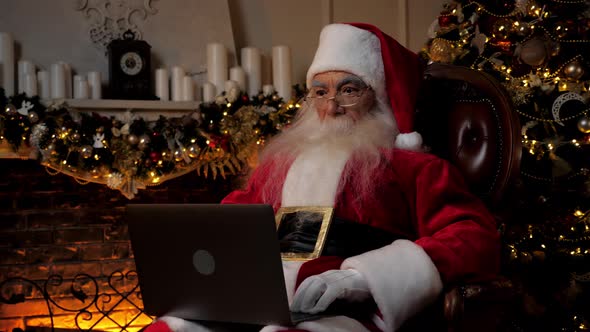 Modern Surprised Santa Claus Listens Children Online Webcam Laptop Video Call alt