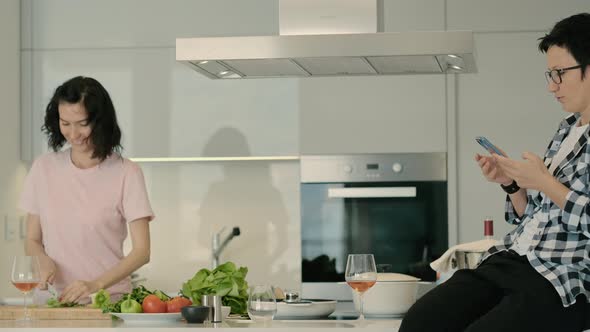 Lesbians Couple in Kitchen Cook Food and Surf Online with Phone Rbbro alt