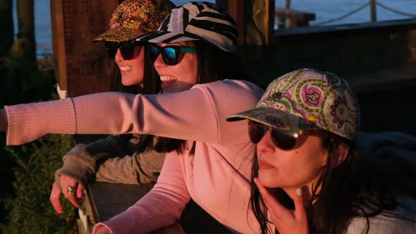 group of cheerful women looking at the sea with cap, pichilemu, punta de lobos, surf beach.Chile. alt