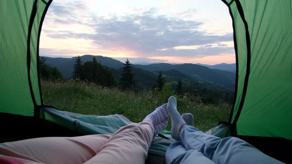 A Loving Couple is Resting in the Mountains They are Sitting in a Tent and Talking alt