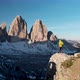 Aerial Man Hiker Walk In Front of Cadini Mountain in Dolomites Italy - VideoHive Item for Sale